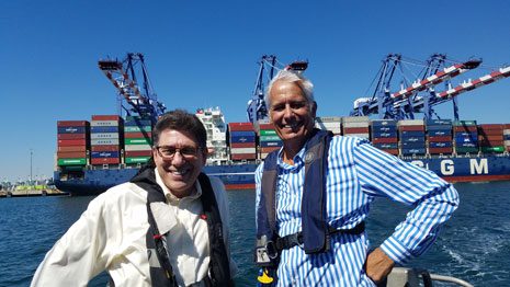 John Betz '96 giving Chancellor & Dean Faigman the experience of a port pilot at the Port of Los Angeles.