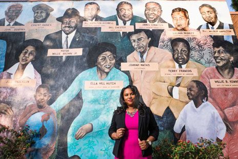 Elizabeth McGriff '96 next to a mural featuring her mother