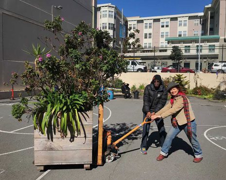 Kasey Asberry with helpers from the neighborhood moving the Demonstration Gardens to its new home.