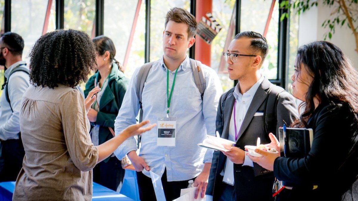 Various UC Law SF students listening intently to a Staff member in the Dining Commons