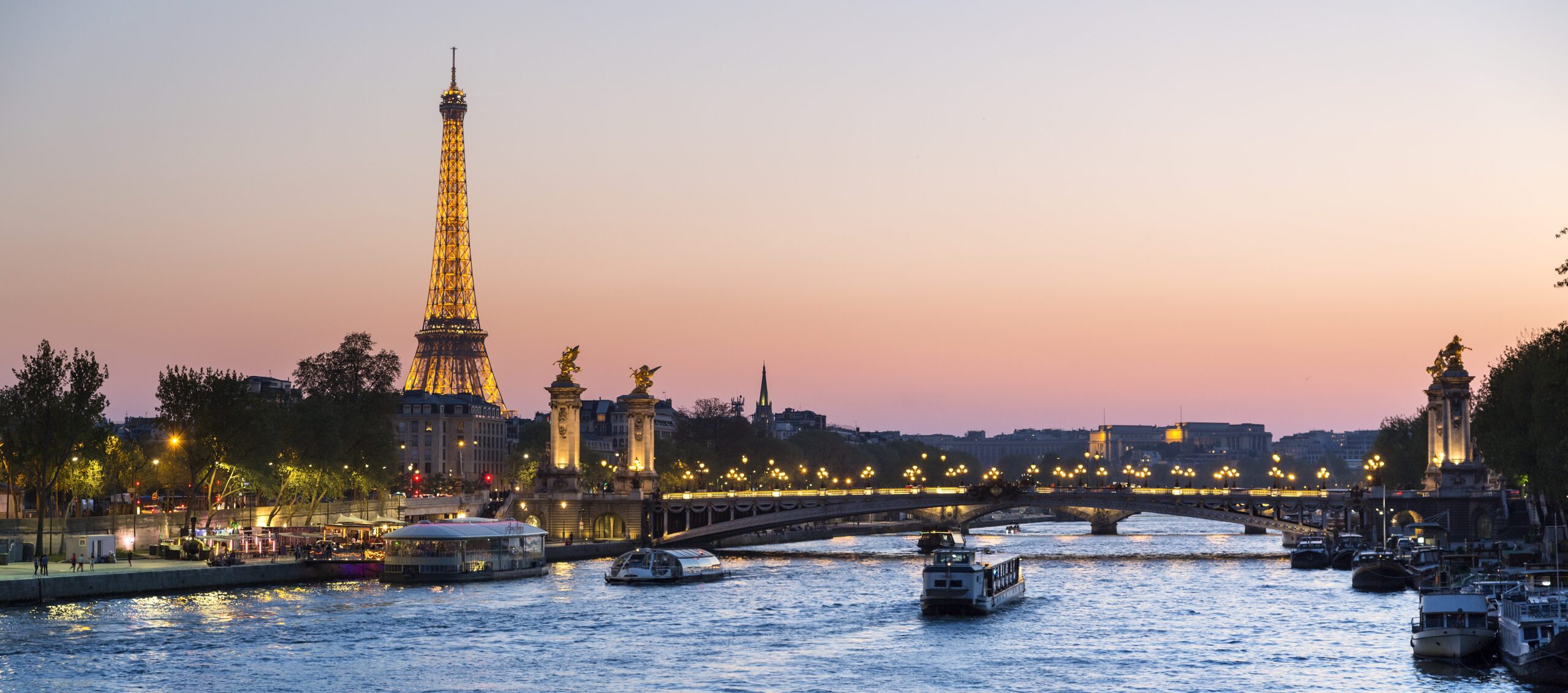 Paris, traffic on the Seine river at sunset, with Eiffel tower in background