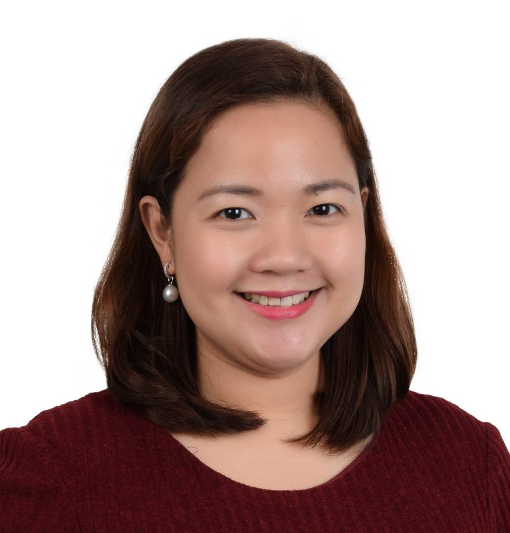 Woman wearing a red top smiling and looking at the camera