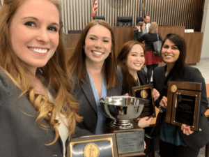 Moot Court contestants pose with trophies 