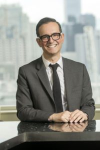 headshot of Morris Ratner sitting at desk