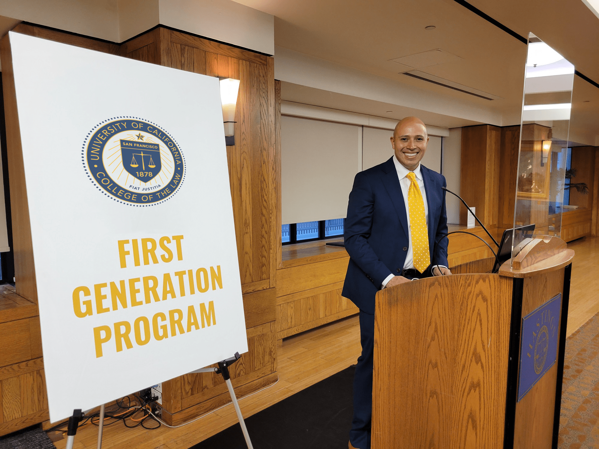 Mario Ernesto Lopez near a First Generation Program sign