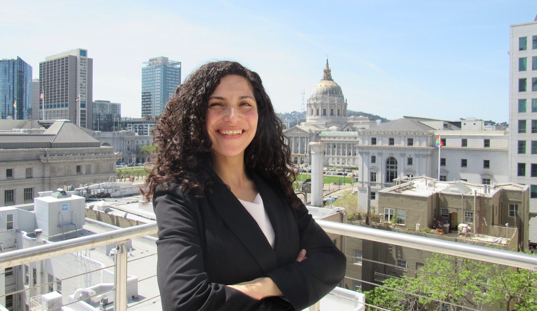 UC Law SF studen Rosamaria Cavalho poses with San Francisco City Hall in the background