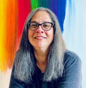 A picture of Allison Wang in front of a colorful backdrop