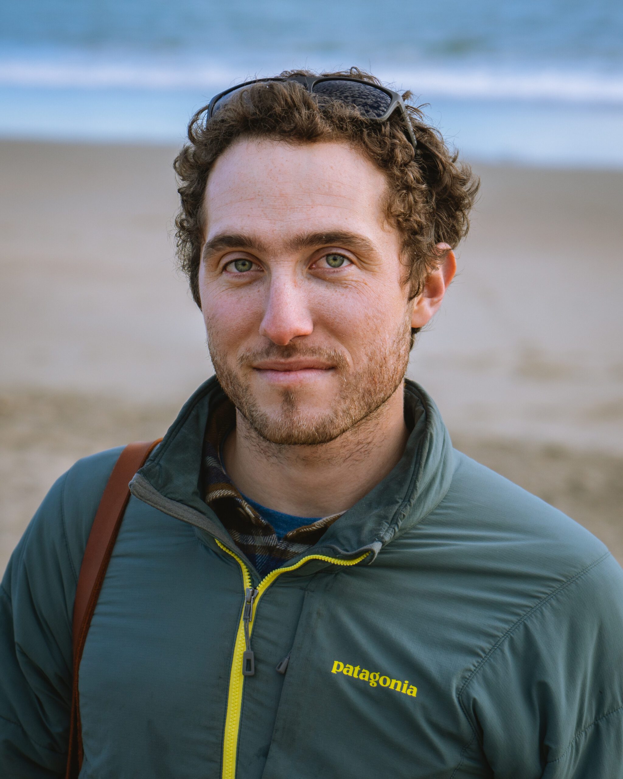 Smiling young man poses at beach