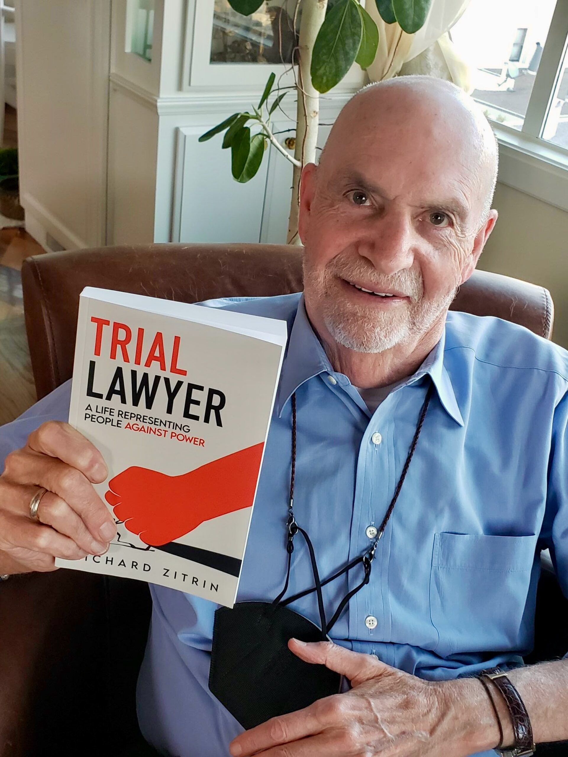 bald law professor holds book