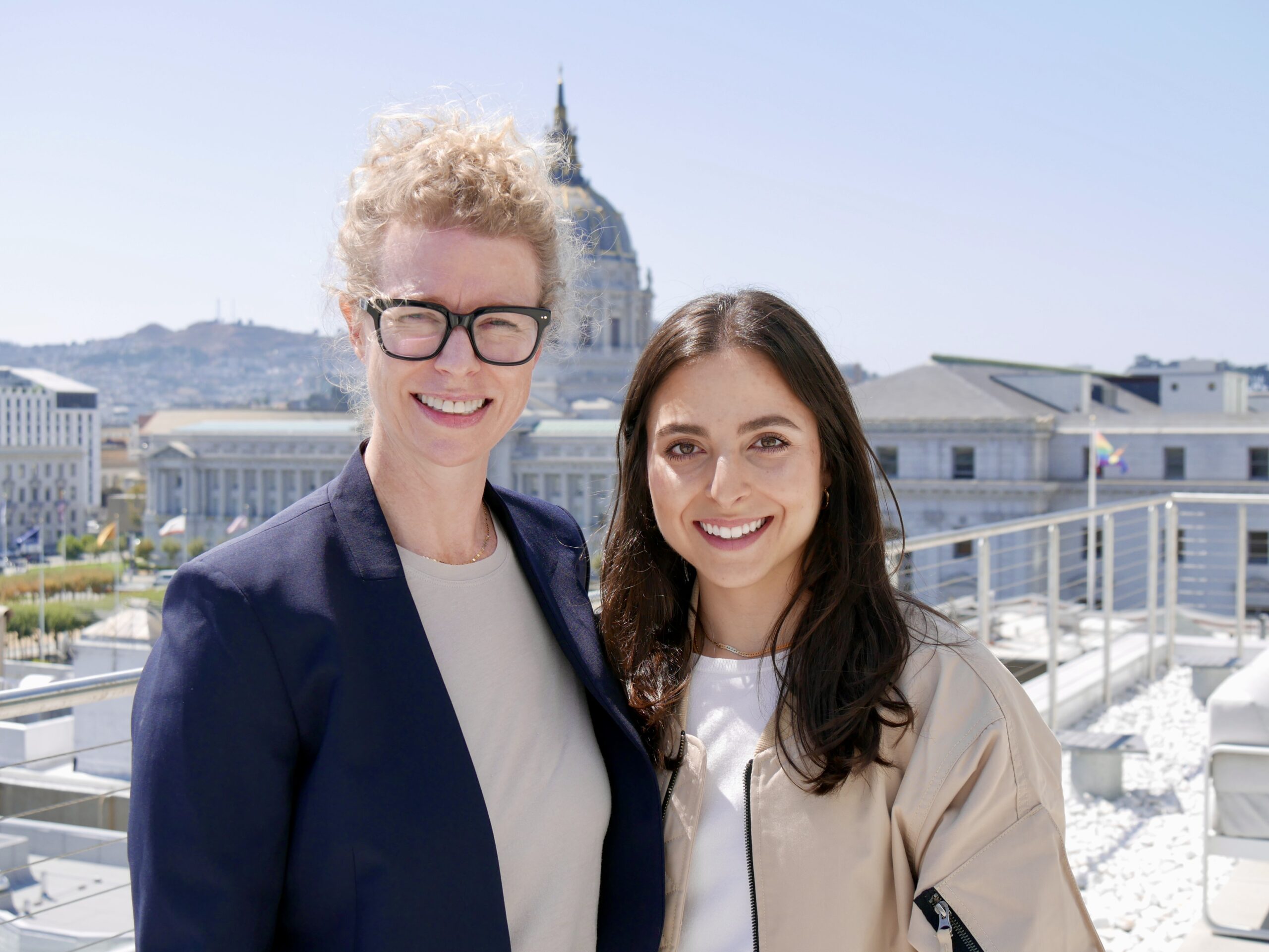 two women standing in front of San Francisco City Hall