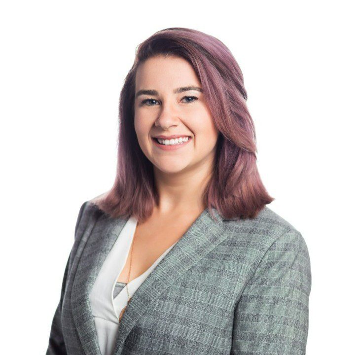 UC Law SF student Rachel Pyle smiles in a professional setting, wearing a gray blazer over a white top. The background is plain white.