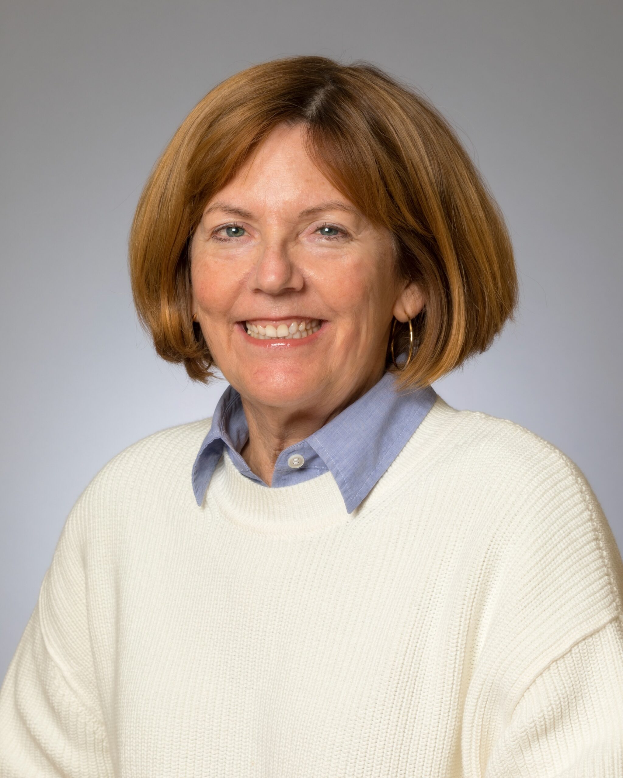 professional woman wearing sweater and collar shirt