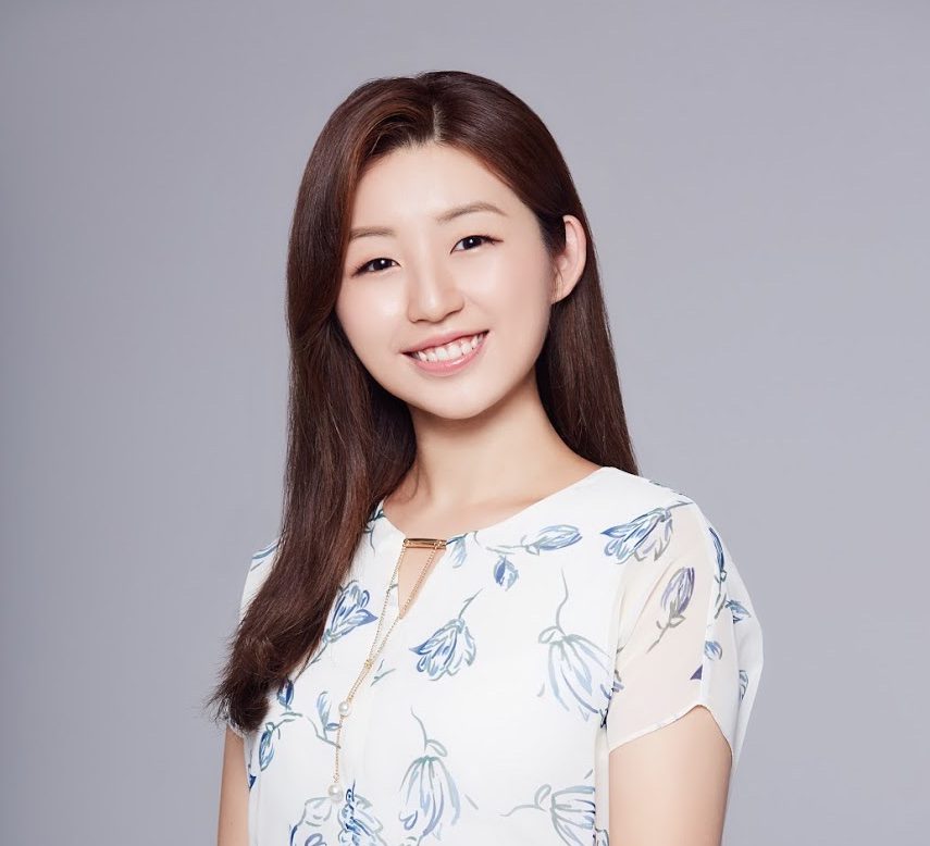 Hannah Park smiles while wearing a floral-patterned blouse against a plain gray background. She is a member of the UC Law SF Moot Court Team.