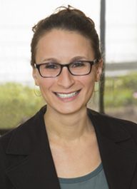 Liz Morris, deputy director of the Center for WorkLife Law, smiling in a professional setting with natural light in the background.