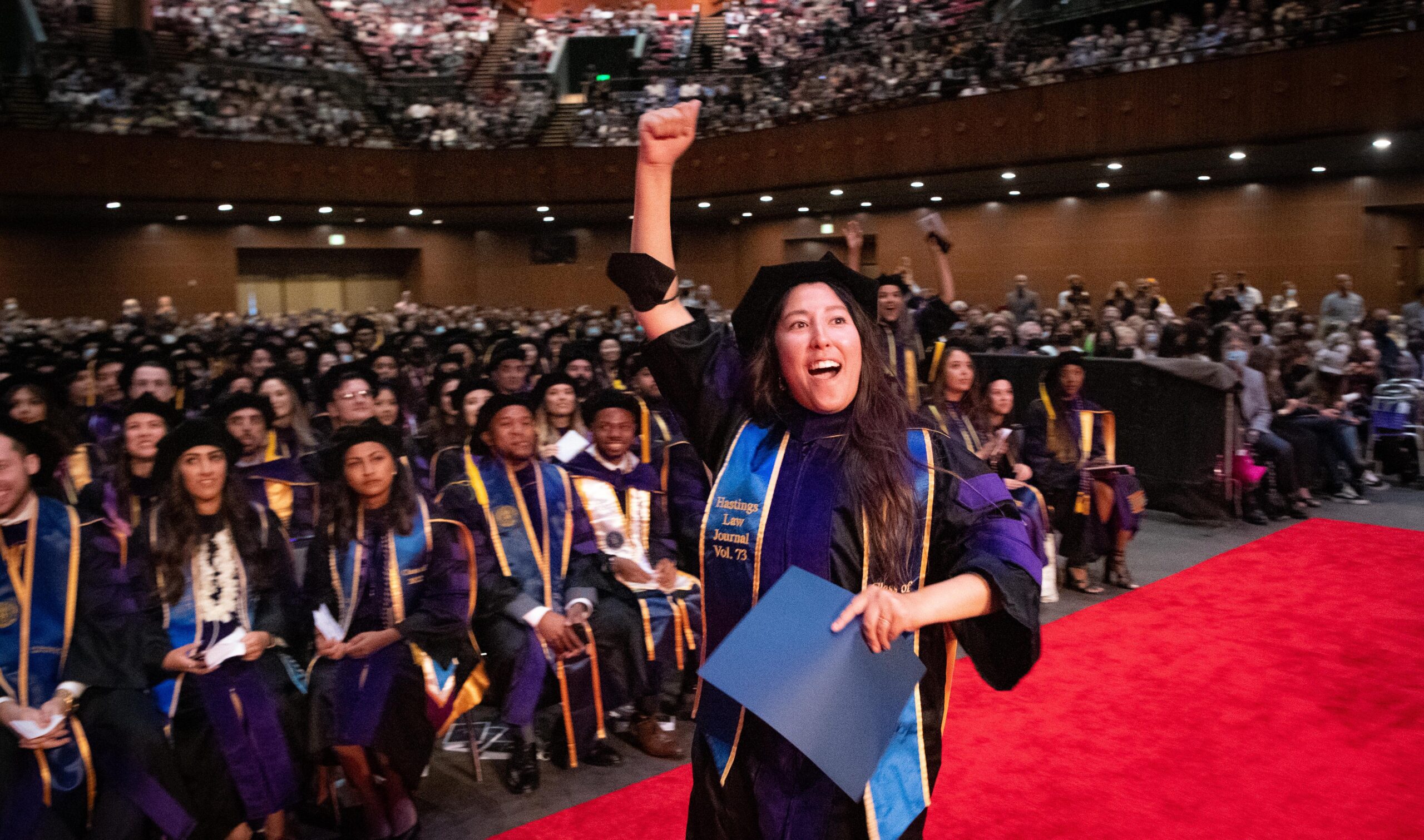 A graduate celebrating at the commencement ceremony