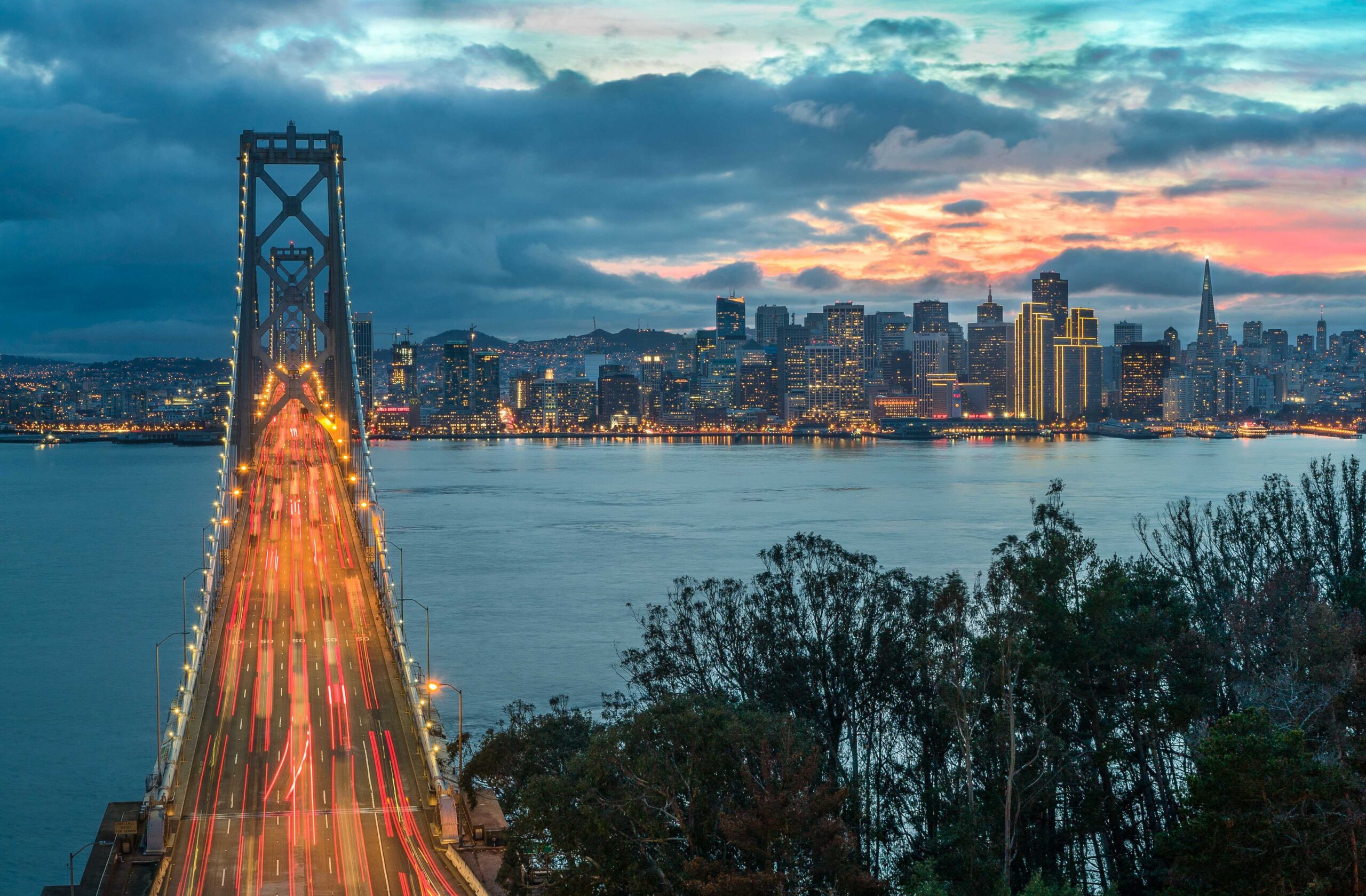 golden gate lit up at night with traffic