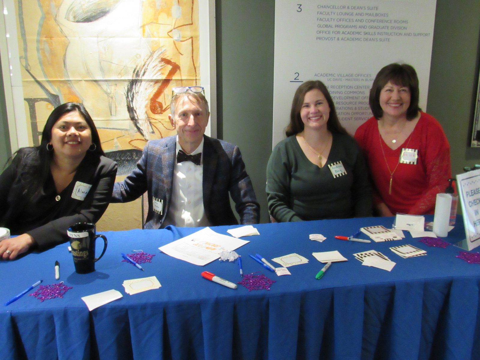 Staff volunteeers welcoming employees to the annual holiday party