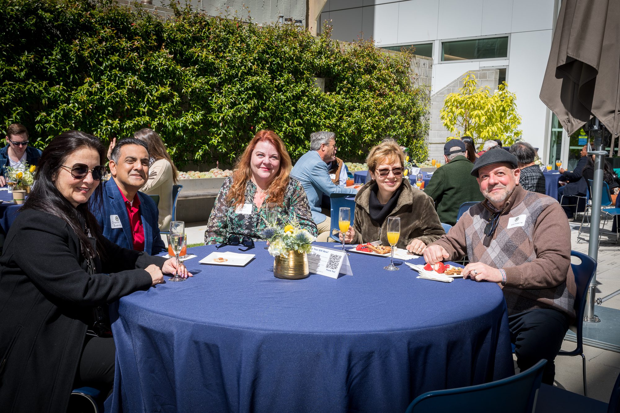 A group of UC Law SF alumni sitting in the quad for the Jazz Brunch