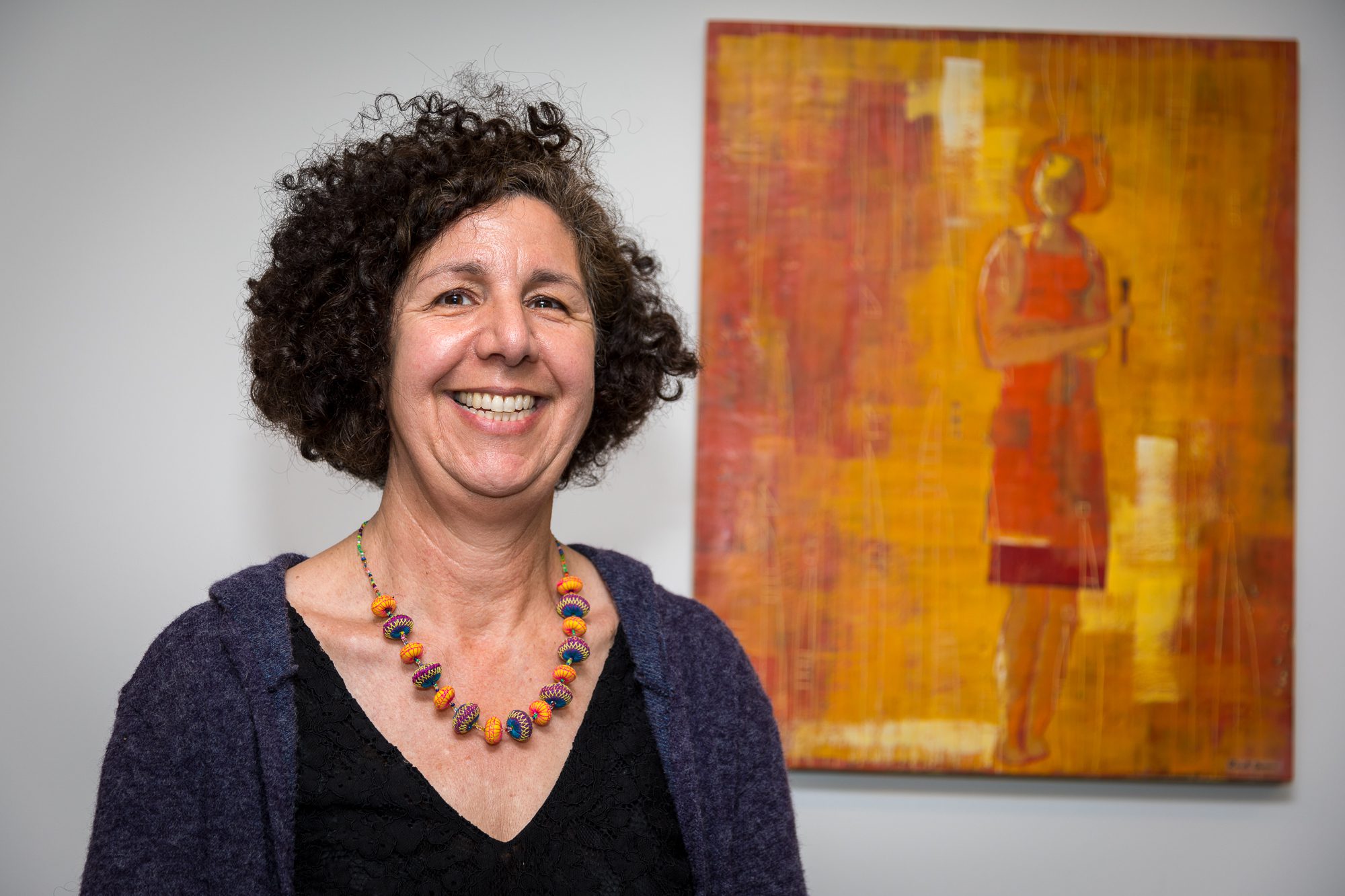 Artist Rinet Goran in front of her piece “With a Brush," which is on the sixth floor of Mary Kay Kane Hall.