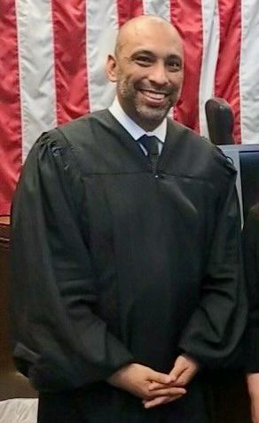 David Pereda wearing black judge robes