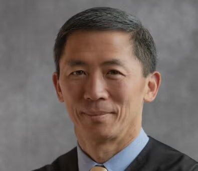 Justice Goodwin Liu wearing black robe and yellow tie.
