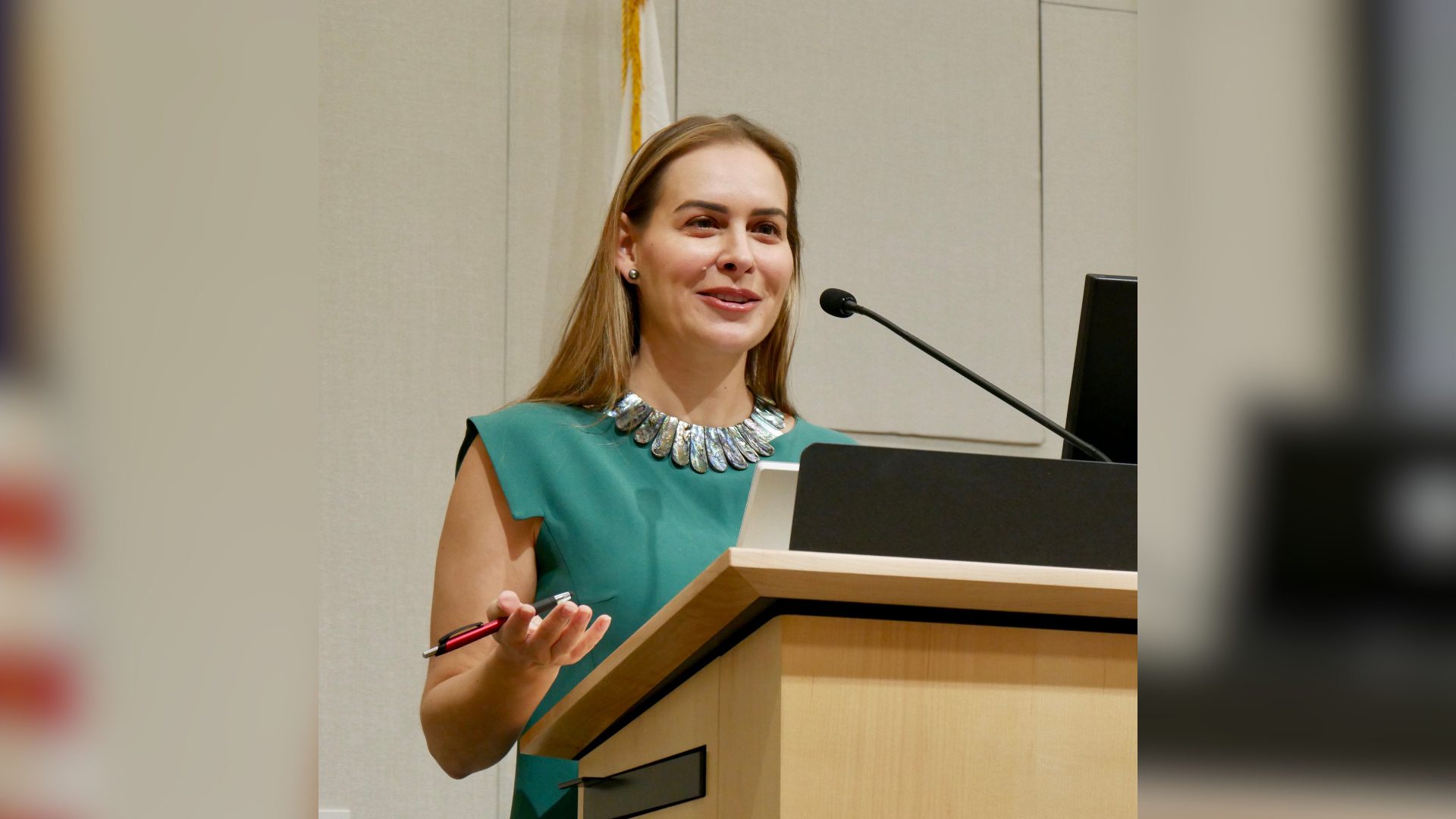 Brittan Heller stands behind a podium at the UC Law Journal Symposium.