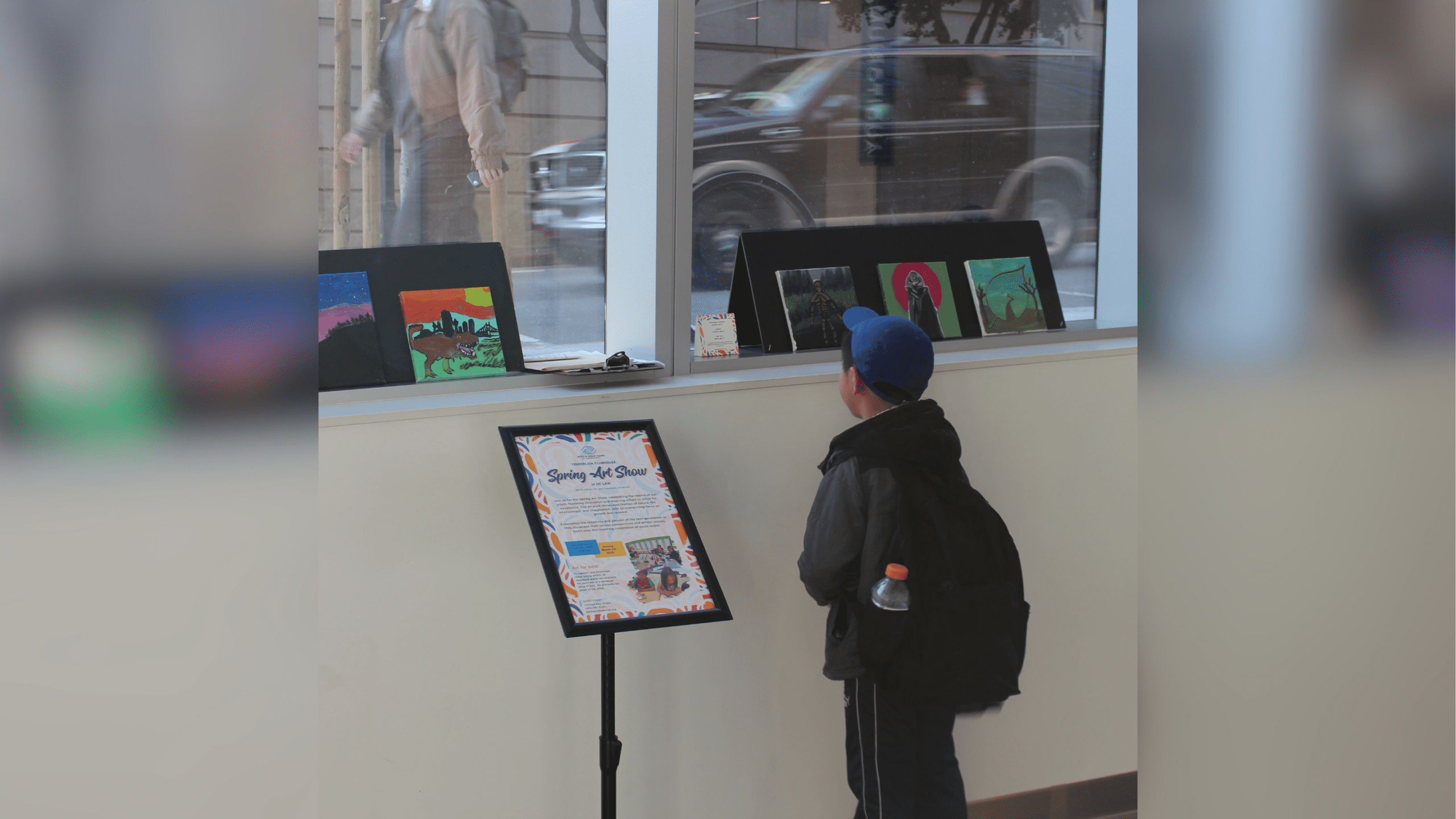 A child looking at paintings