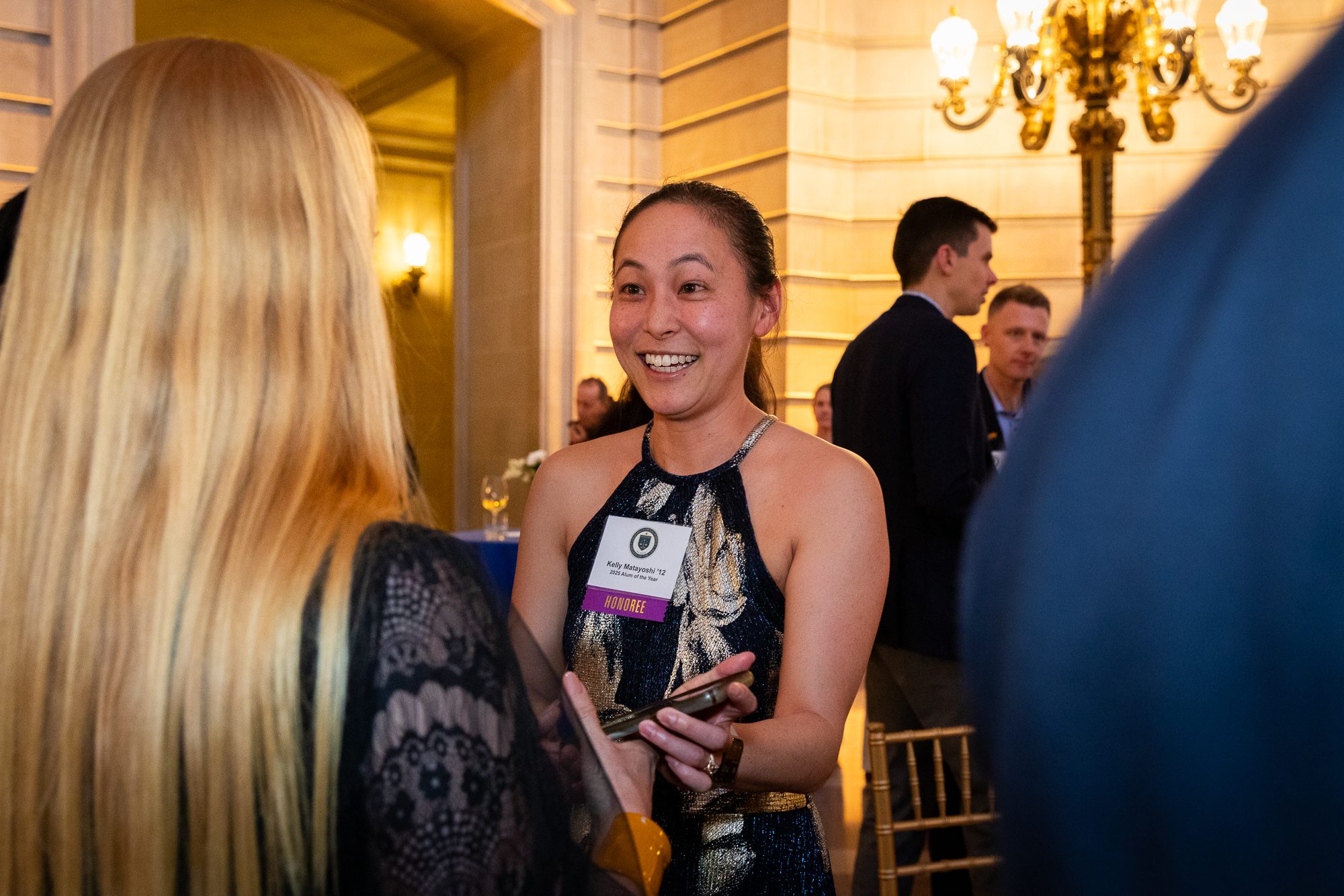 Kelly Matayoshi smiles as she greets an attendee of the All Alumni Party at San Francisco City Hall.
