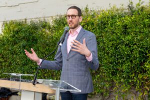 State Sen. Scott Wiener speaks while standing at a lectern.
