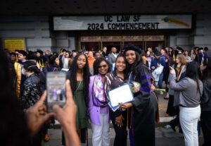 A family taking a photo with their graduate after the commencement ceremony