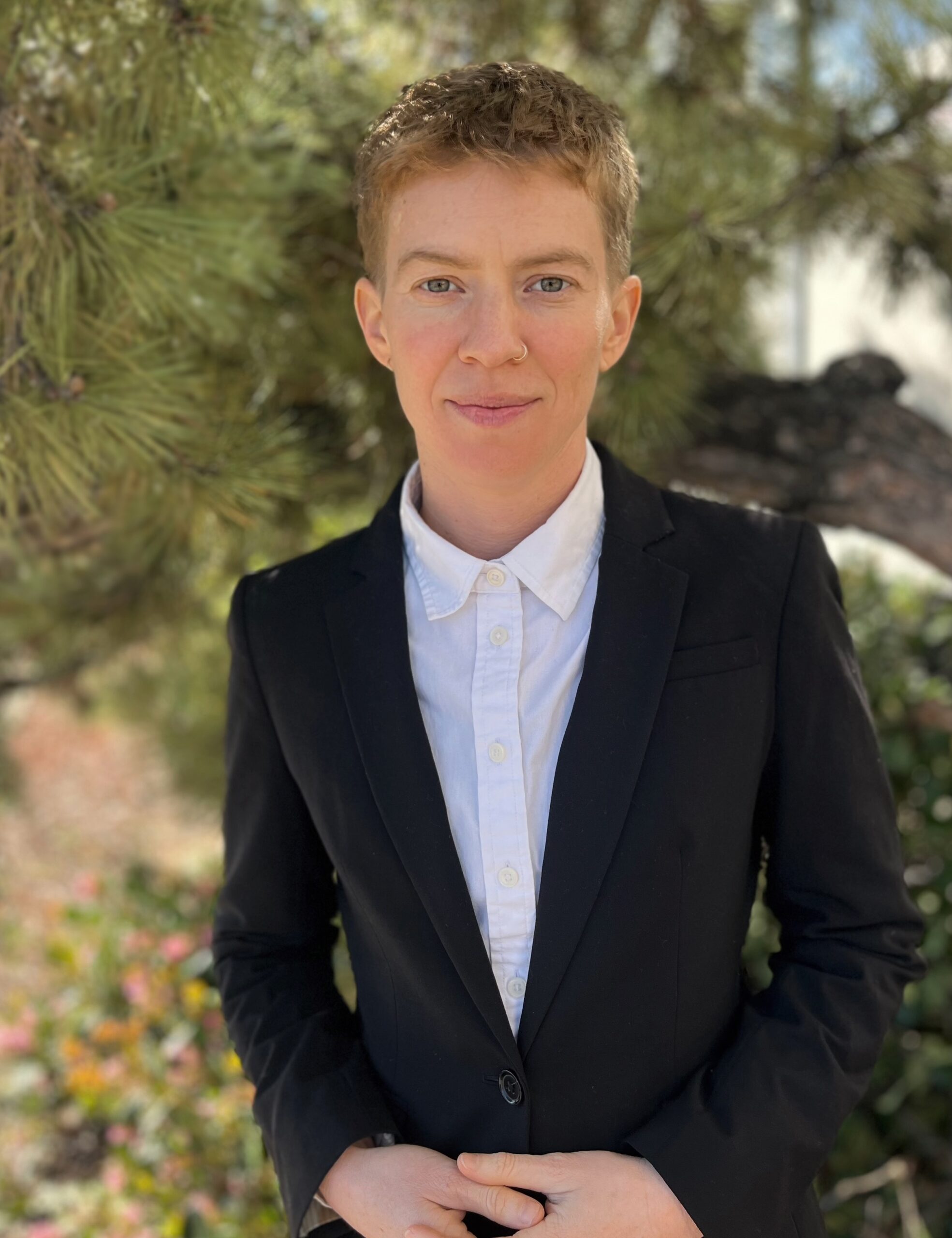 Headshot of Nat Williford with short sandy blonde hair and wearing business attire