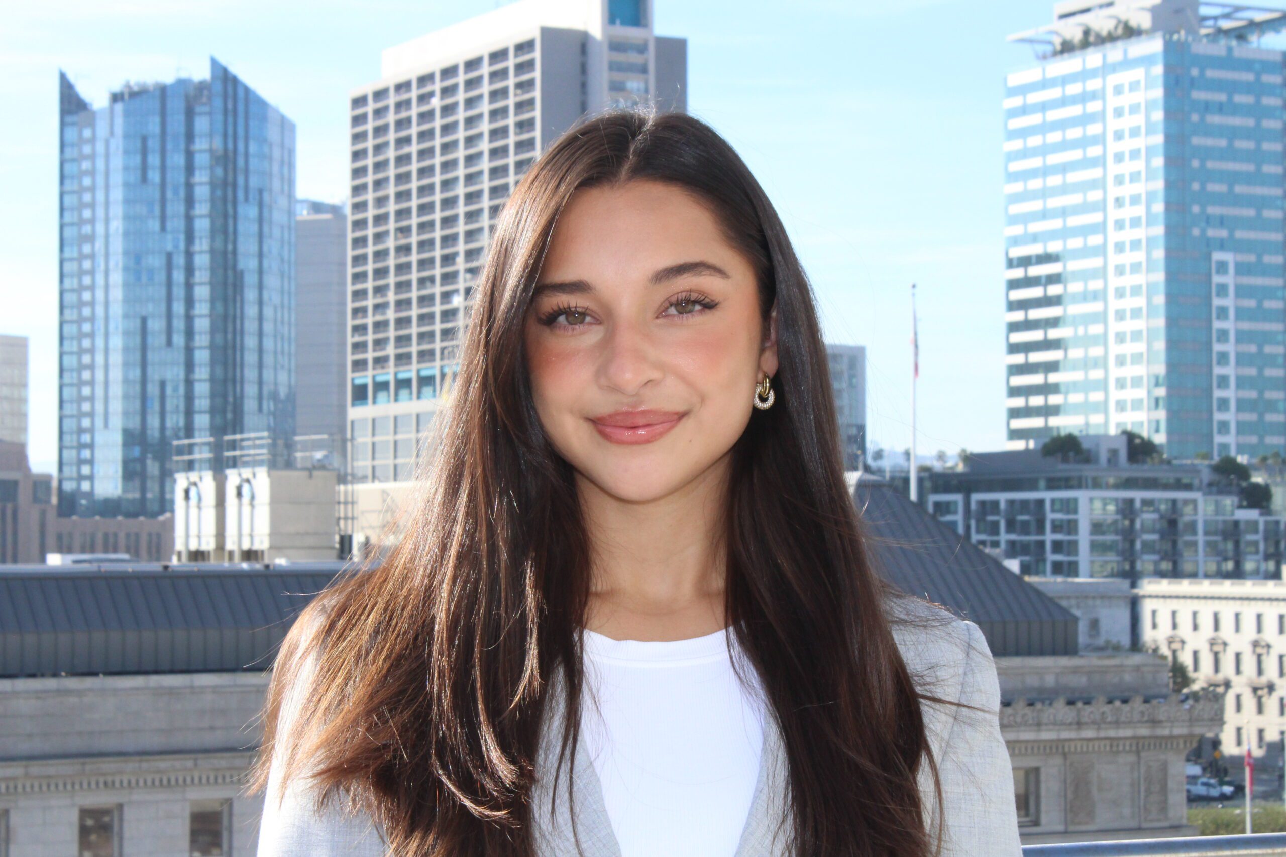 Headshot photo of law student Renee Applegate standing in front of a skyline in business attire.