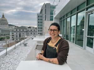 A portrait Yasmin Thompson with the San Francisco Civic Center in the background.