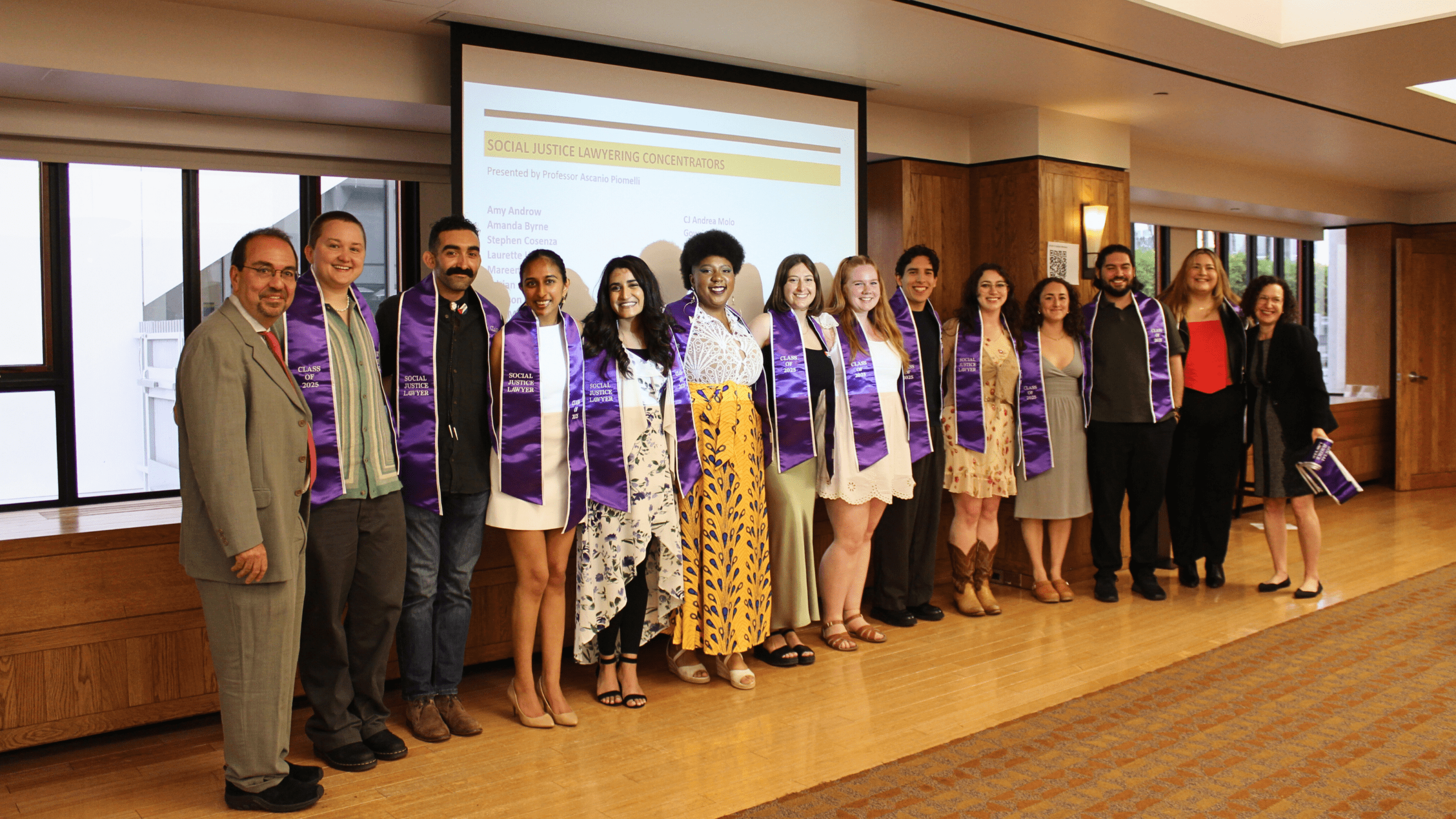 A group of Social Justice Lawyering Concentrators with purple stoles that read 