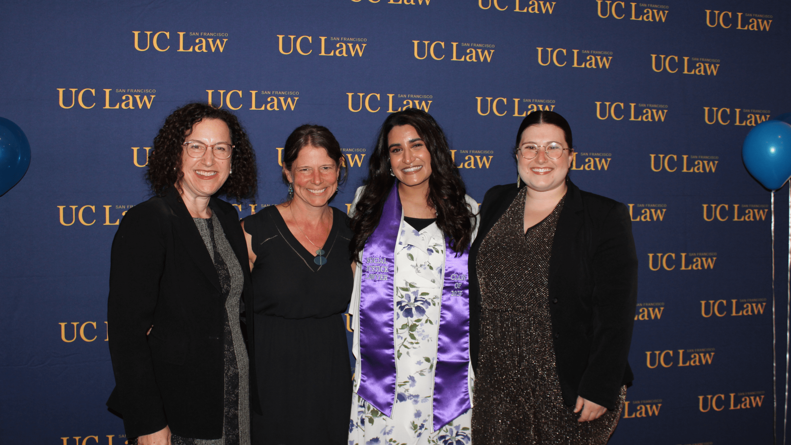 Gail Silverstein, Brittany Glidden, and Simone Levine with a student graduating with the Social Justice Concentration