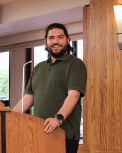 Graduate Ricardo Parada speaking in the Alumni Reception Center