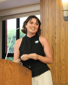 Graduate Mischa DiBattiste speaking in the Alumni Reception Center