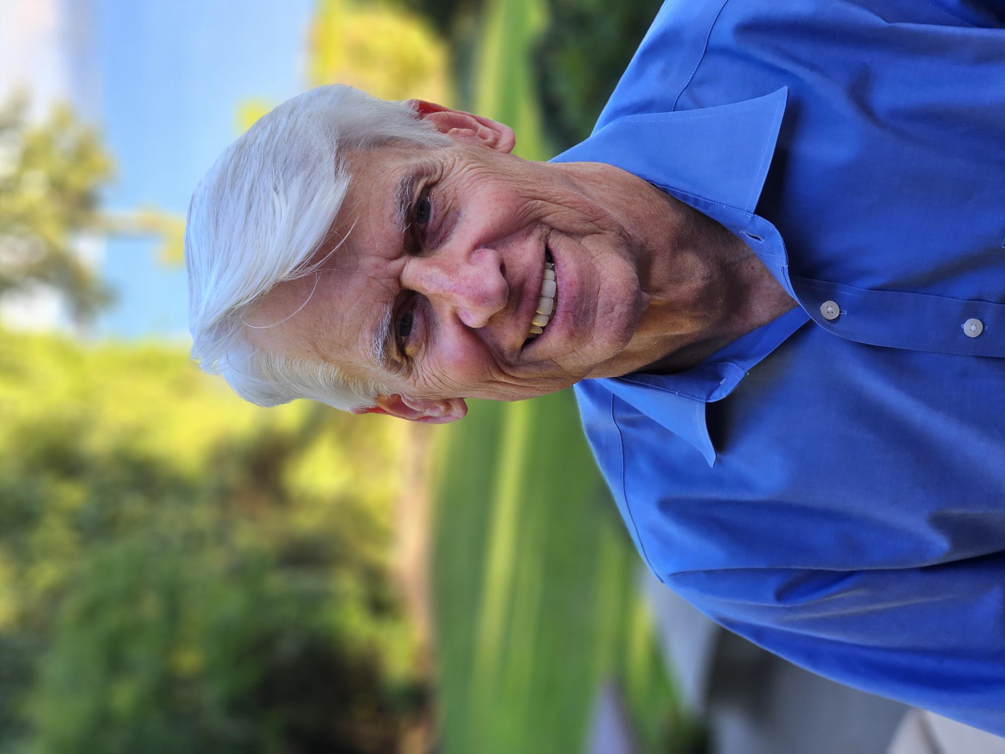 A headshot of Scott Morris posing outdoors in a blue polo shirt.