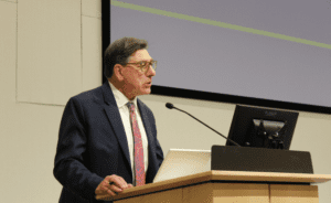 Chancellor and Dean David Faigman speaks from a lectern outfitted with a microphone and monitor. 