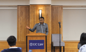 Ernest Hammond speaking at a podium in the Alumni Reception Center for the First Generation Welcome