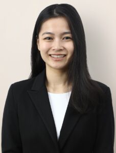 Headshot of Hitomi Ozaki in a white shirt and black suit jacket.