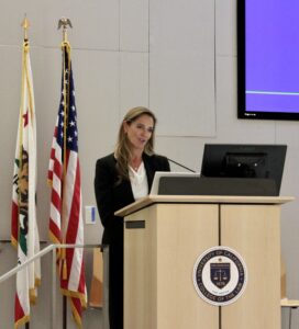 Carol Chodroff speaks behind a podium