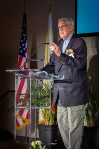 Joseph W. Cotchett ’64 speaks from a lectern.