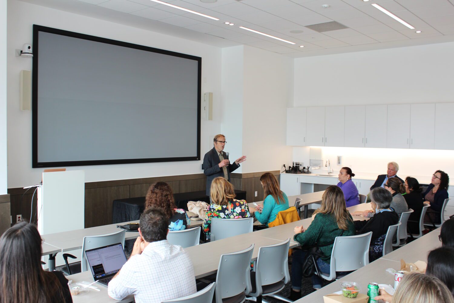 Randy Shaw speaks before an audience at the front of a classroom.
