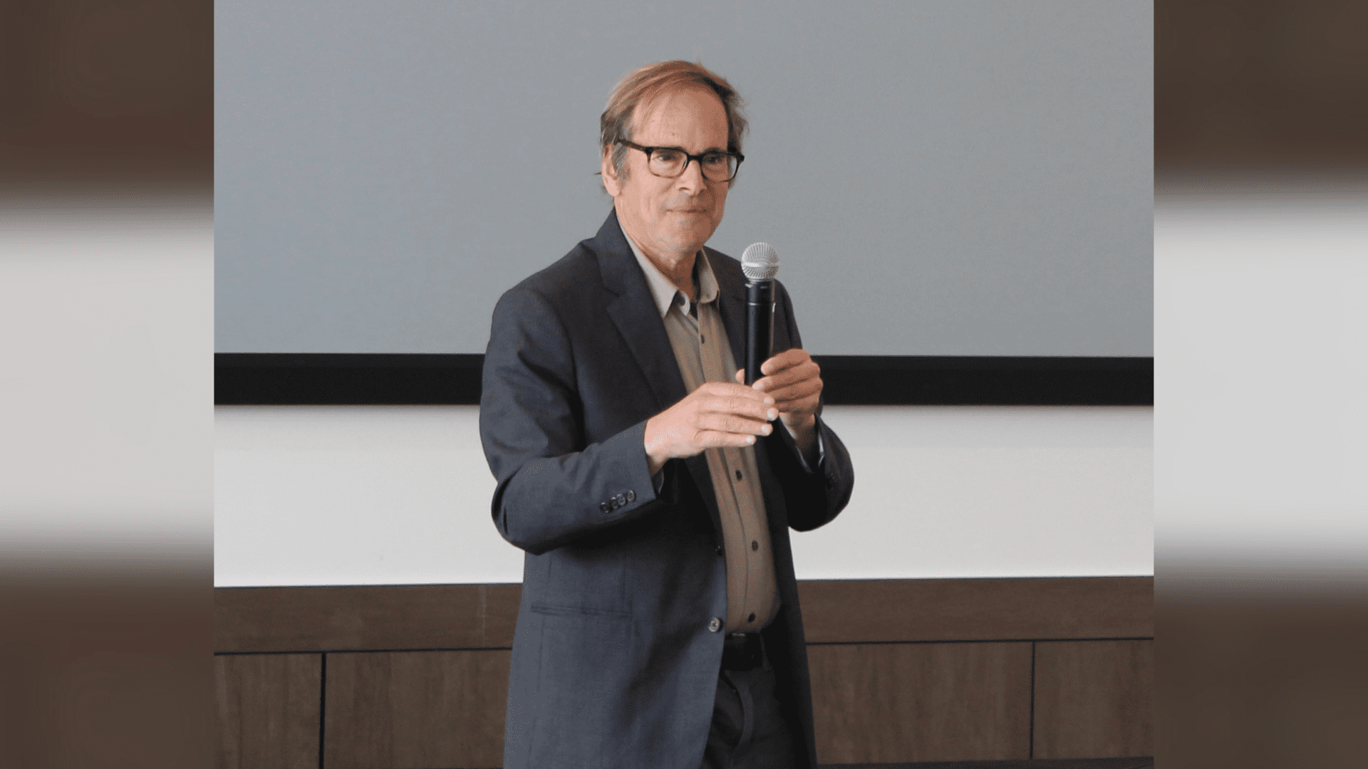 A photo of Randy Shaw speaking with a microphone.