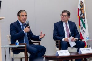 Rob Bonta, seated to the right of David Fagiman, speaks into a microphone.