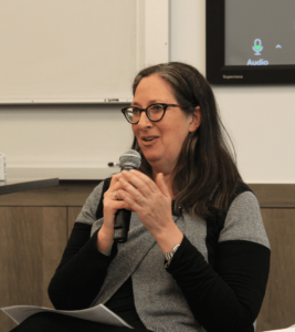 Nicole Ozer with a microphone