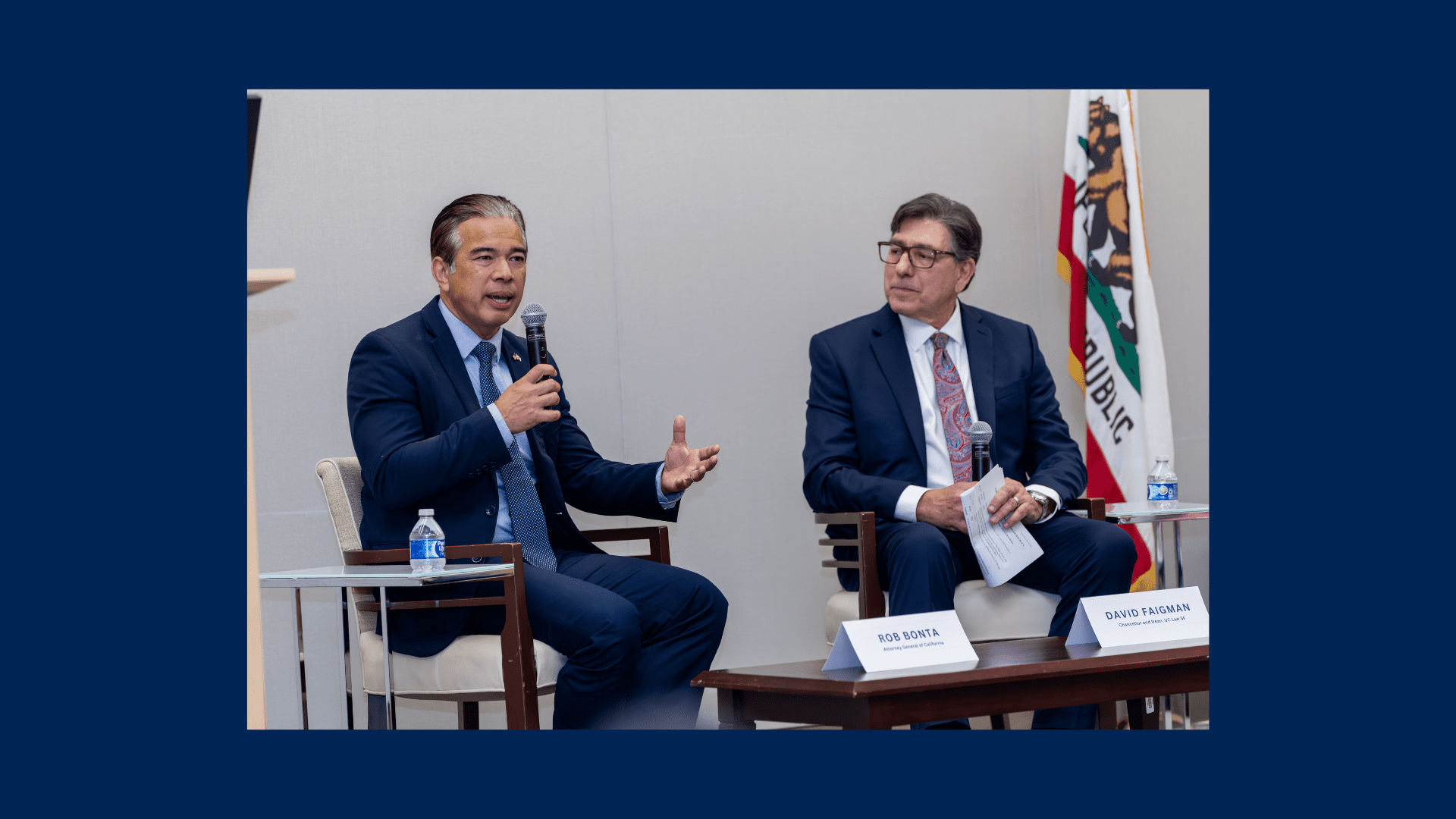 Rob Bonta, seated to the right of David Fagiman, speaks into a microphone.