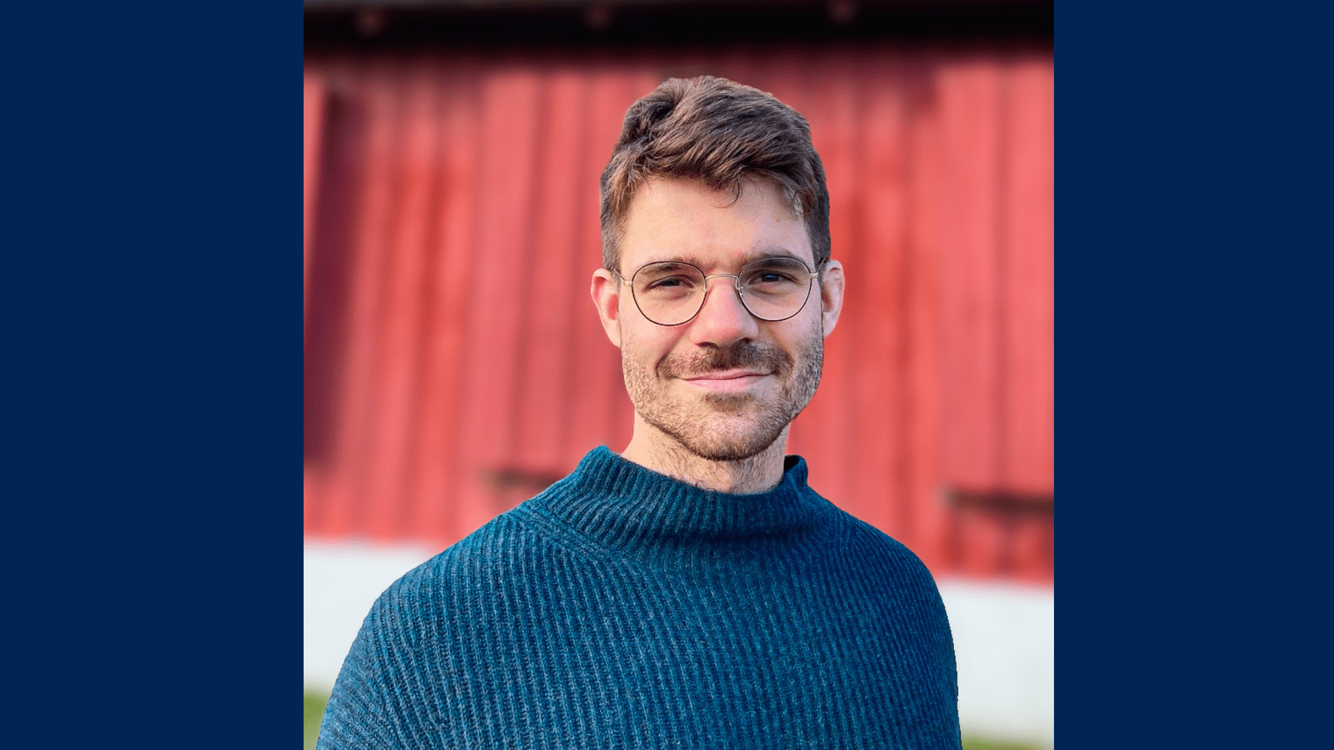 a headshot photo of Benjamin Barsky in a blue sweater with eyeglasses and a mustache.