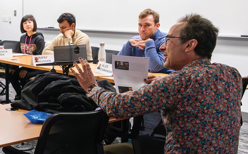 A professor speaking in front of students